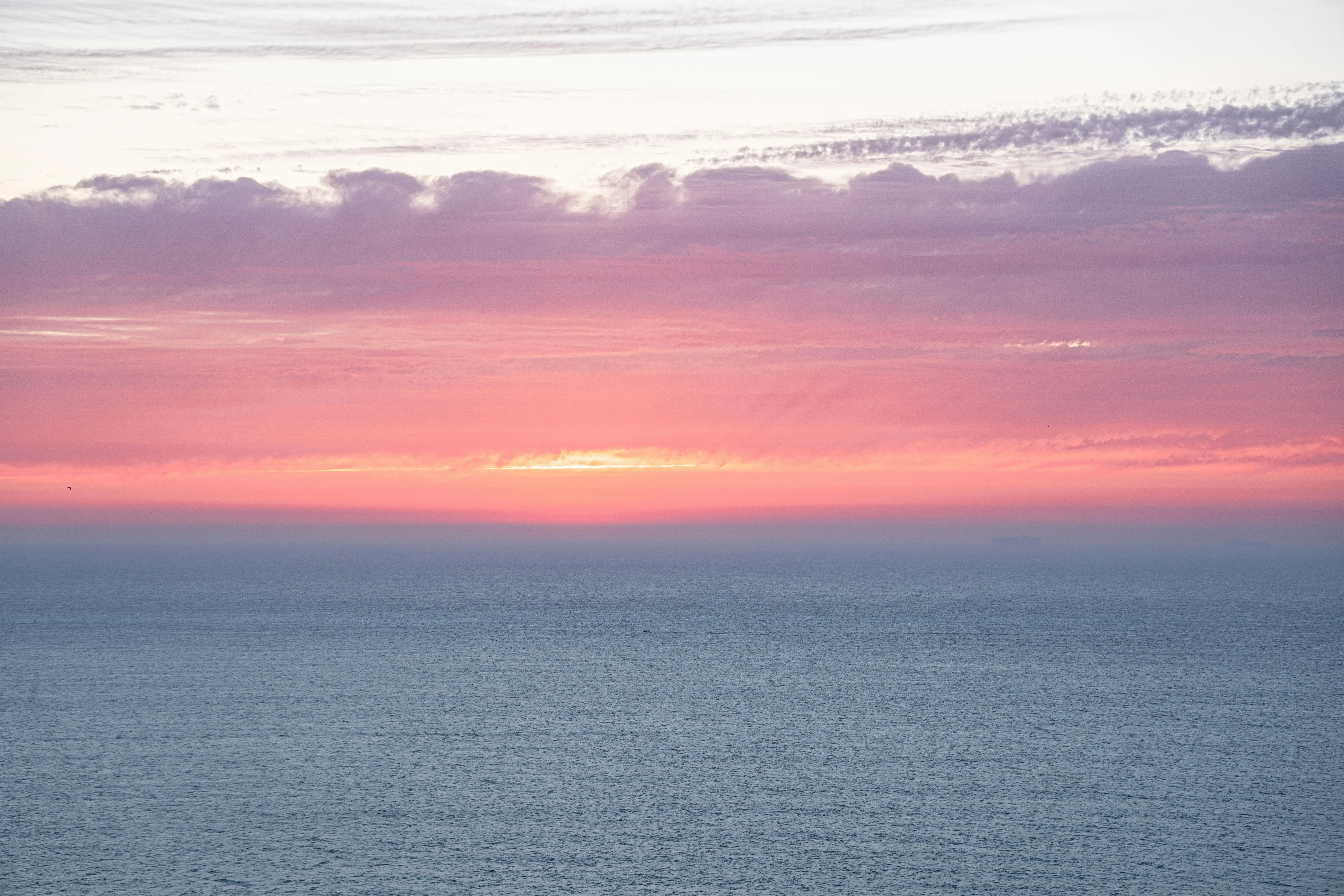 Ocean with pink sunset